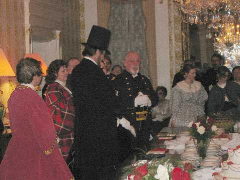 Col. Henry presents President Lincoln with a gift from Mr. & Mrs. Tinsley and requests Mr. Lincoln cut his cake.